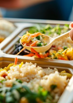 long shot Photo of diversity person is eating ready-to-eat fency meal in an eco box --chaos 15 --ar 3:2 --stylize 50 --v 6 Job ID: 36541631-833f-4718-ae05-325685ead134