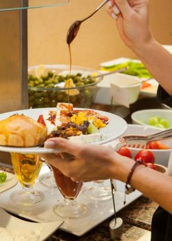 Woman preparing delicious meal in a kitchen . side view.
